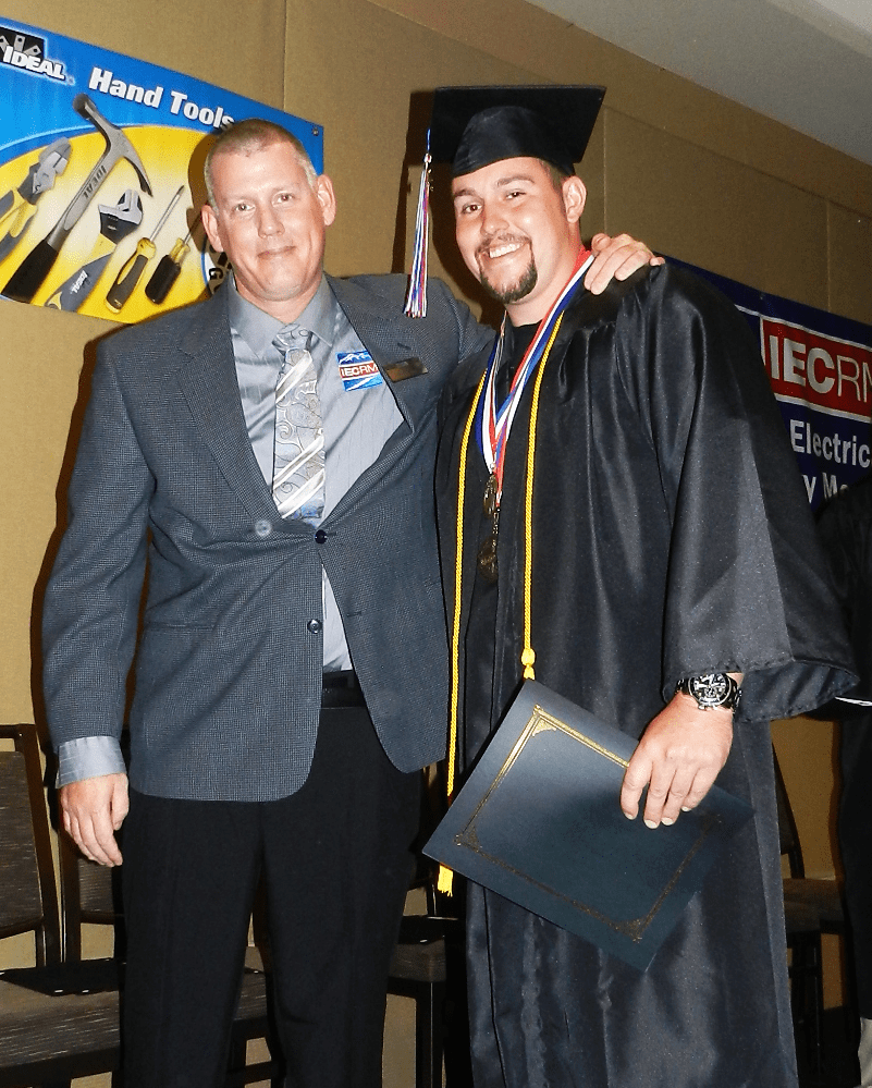 Paul Lingo, Assistant Training Director, with Valedictorian Kole Towner